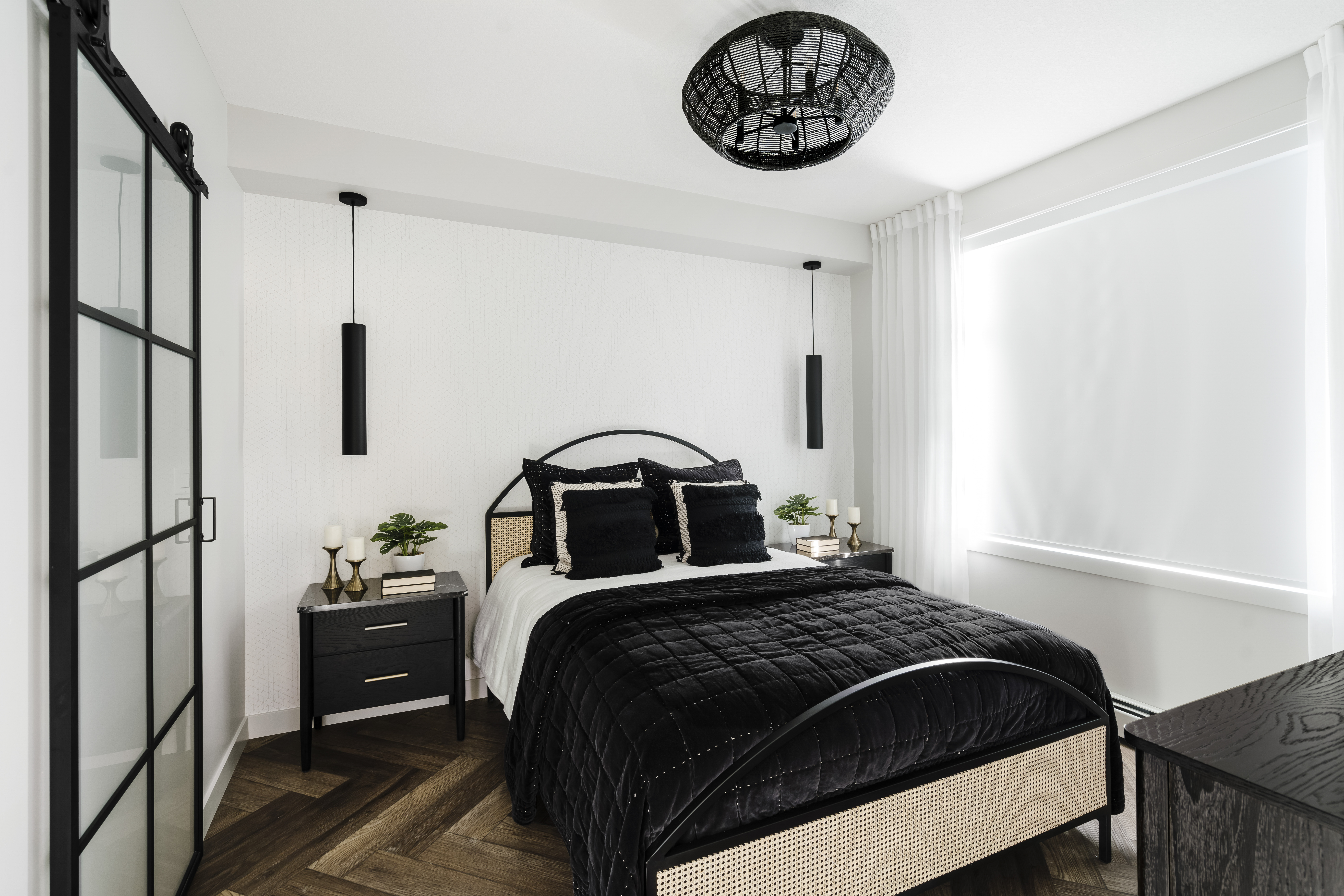 Bedroom with herringbone flooring and black feature lights