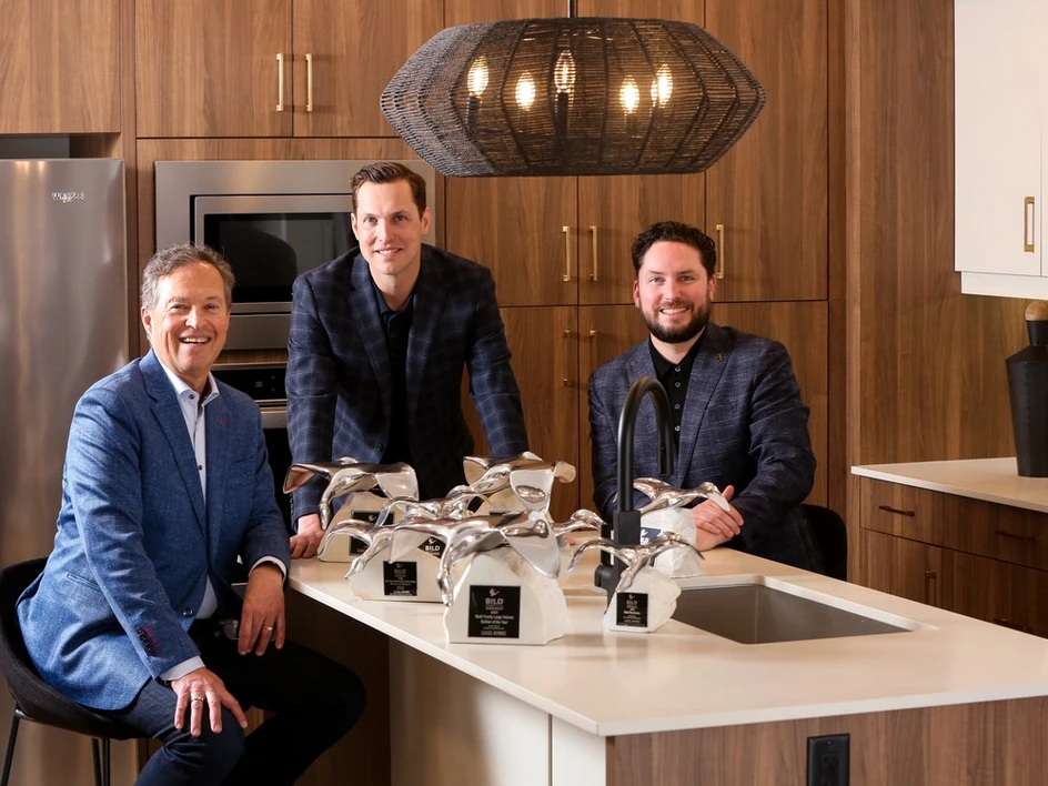 Tim, Kevin, and Brayden Logel in Logel Homes condo surrounded by their 2023 BILD Awards